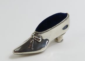 An ornamental, miniature and heeled silver shoe, m
