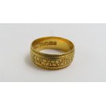 An 18ct gold wedding band, with clover leaves with