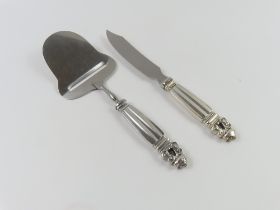 A silver and stainless steel cheese slicer and kni