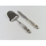 A silver and stainless steel cheese slicer and kni