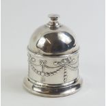 A silver thread holder with silver pair of scissor