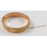 A rose gold half engraved, hollow, hinged bangle, 6cm inte