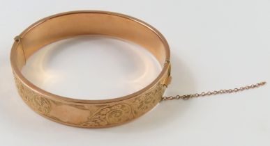 A rose gold half engraved, hollow, hinged bangle, 6cm inte