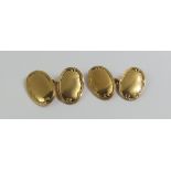 A pair of 15ct gold oval panel cufflinks, with dec