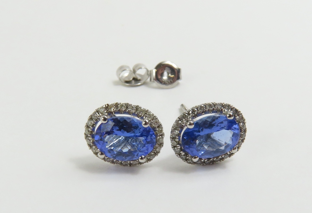 A pair of 18ct white gold tanzanite and diamond cl