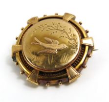 A Victorian aesthetic movement photo brooch, depic