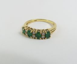 An 18ct gold emerald and diamond ring, the four ov