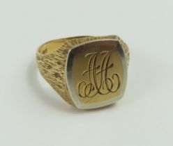 A 9ct gold signet ring, with white gold accent aro