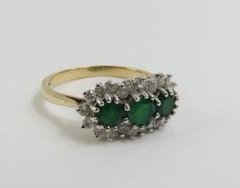 A 9ct gold emerald and diamond triple cluster ring