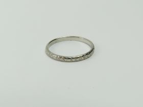 A lightly patterned wedding band, marked 'PLATINUM