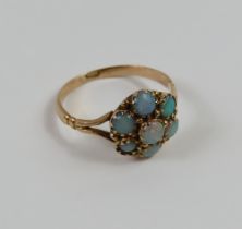 A seven stone opal cluster ring, finger size M 1/2