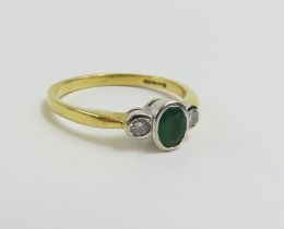 A 18ct gold emerald and diamond three stone ring, r