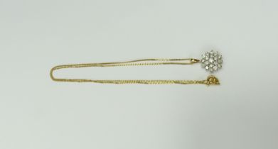 An 18ct gold diamond cluster pendant, 1.7cm long,