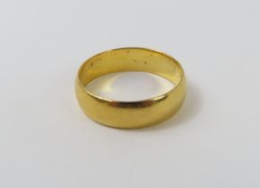 A 22ct gold wedding band, finger size N centre, 4.