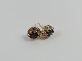 A pair of 9ct gold sapphire and diamond cluster st