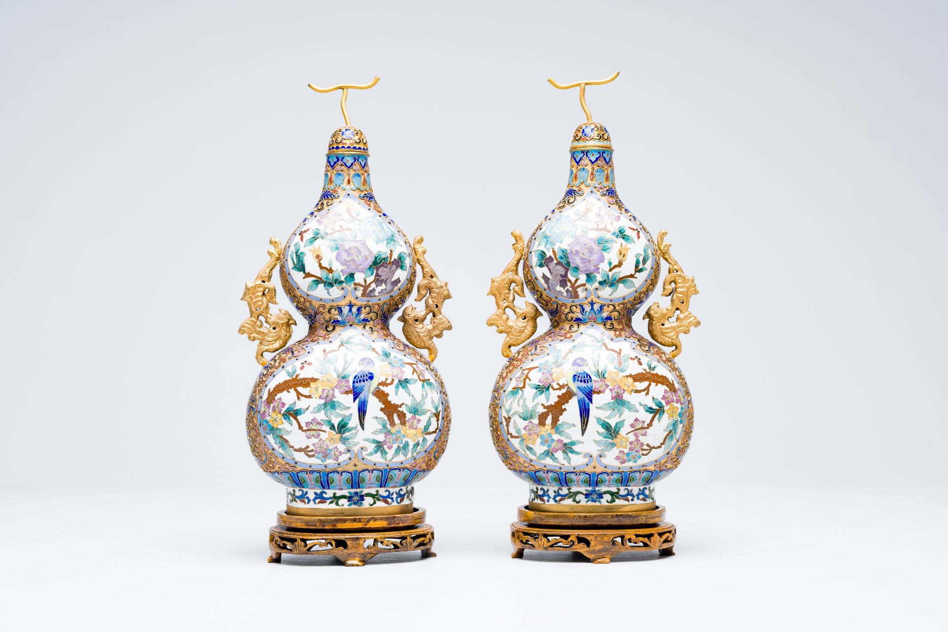 A pair of Chinese cloisonne double gourd vases on wooden stands, 20th C.