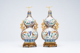 A pair of Chinese cloisonne double gourd vases on wooden stands, 20th C.