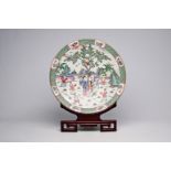 A large Chinese famille rose dish with ladies and children in a landscape, Qianlong mark, 20th C.