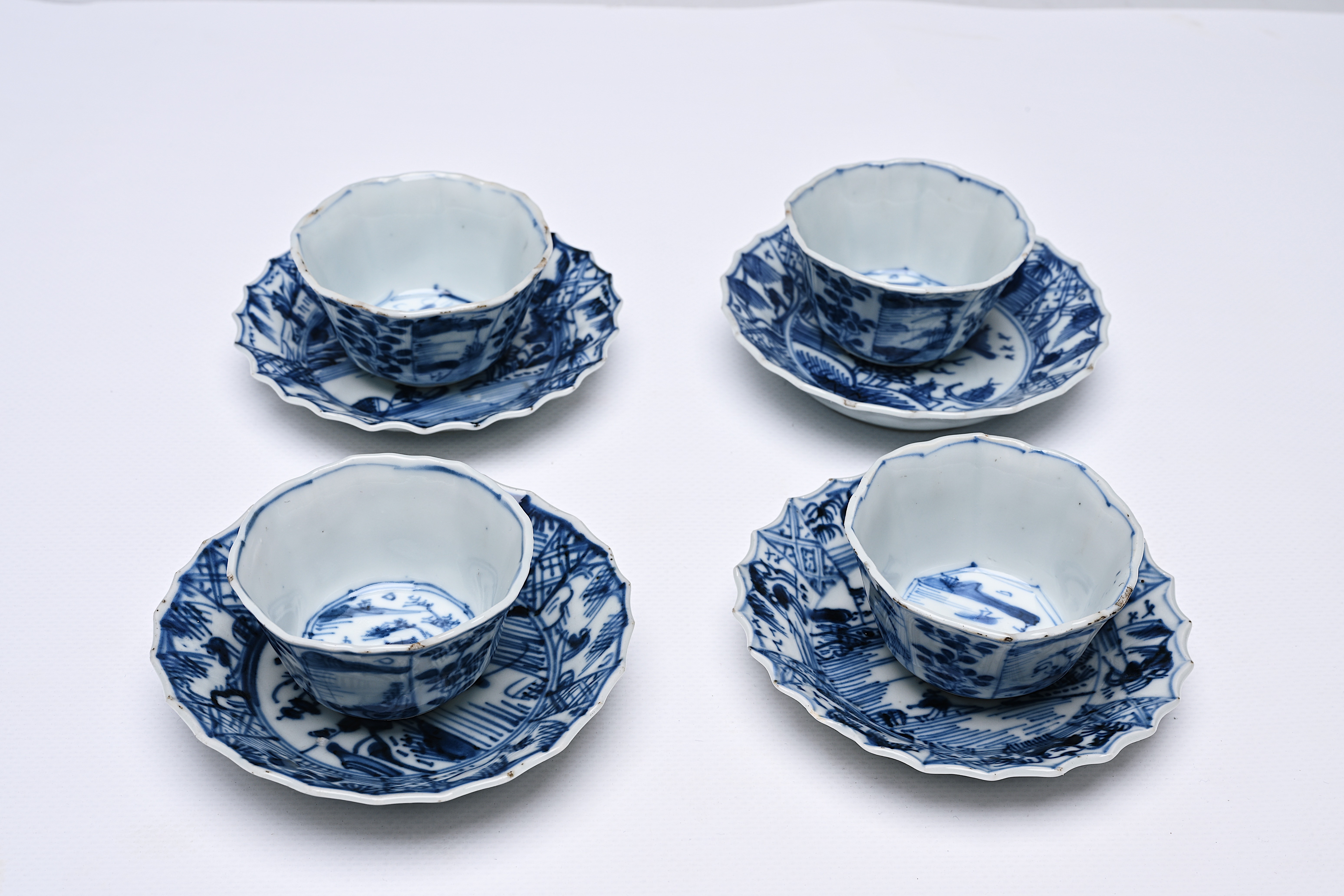 Four Chinese blue and white cups and saucers with floral design and landscapes, Kangxi - Image 12 of 12