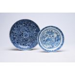 Two Chinese blue and white plates with floral design and figures in a landscape, Kangxi/Qianlong