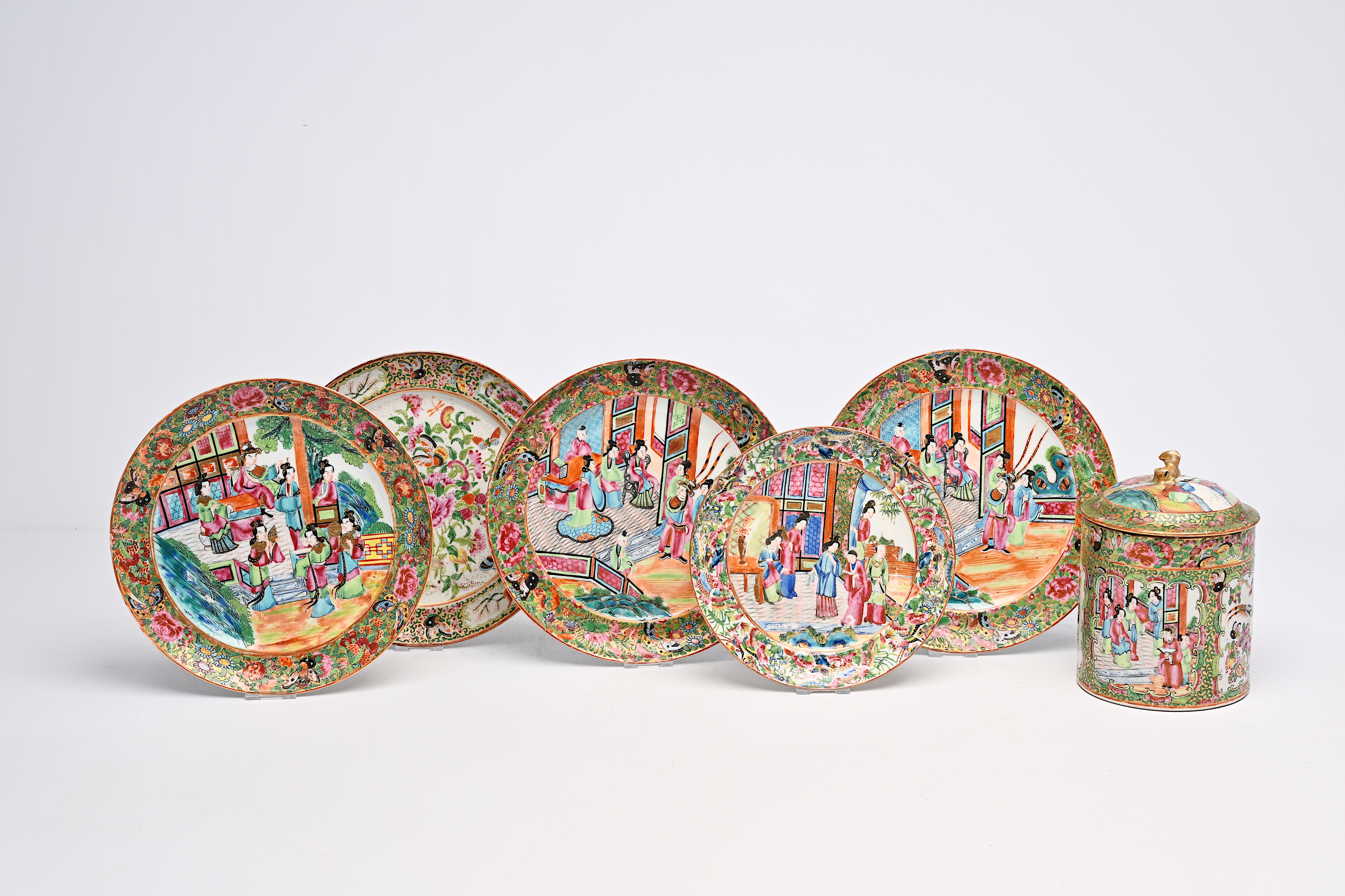 Five Chinese Canton famille rose plates and a jar and cover with palace scenes and floral design, 19