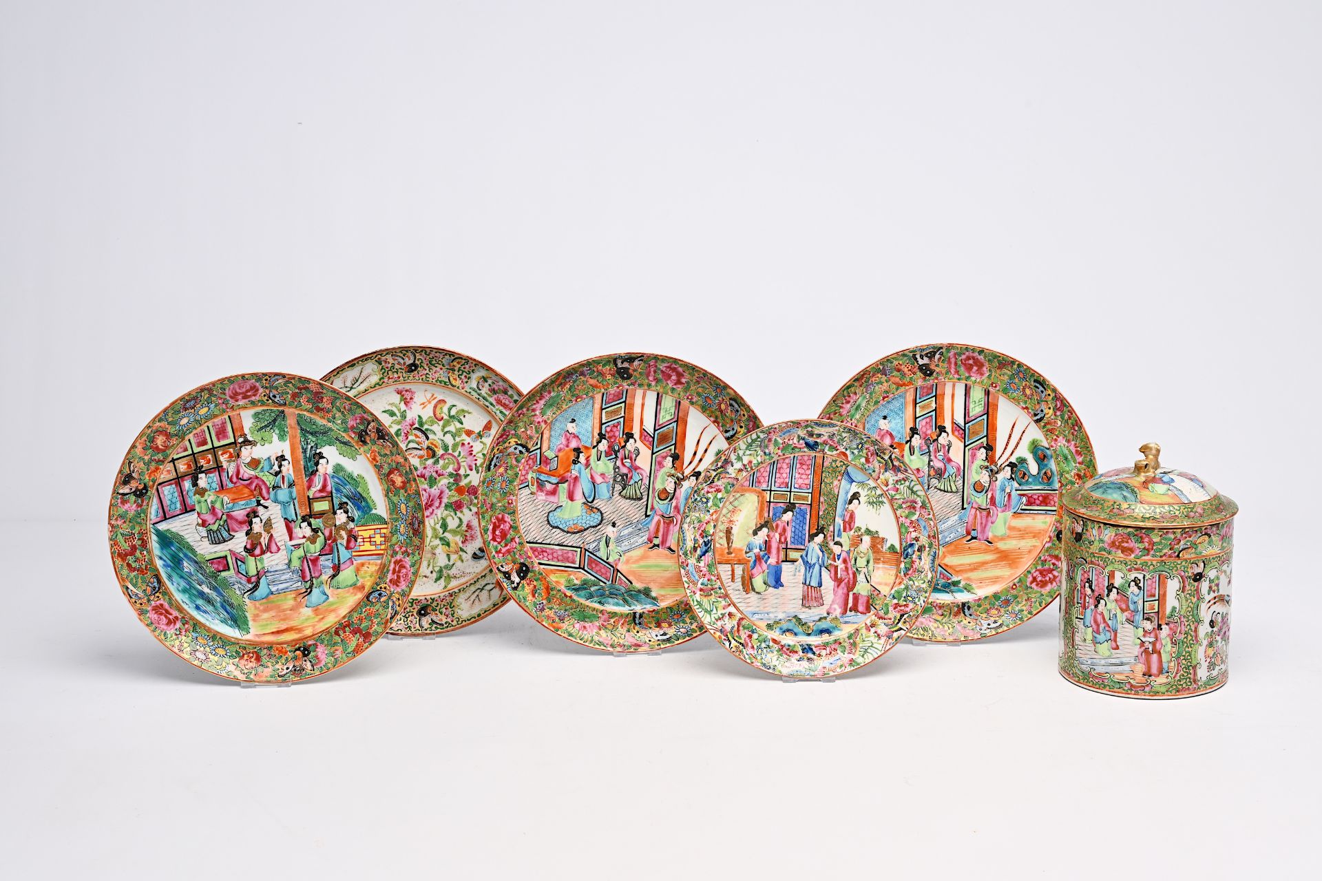 Five Chinese Canton famille rose plates and a jar and cover with palace scenes and floral design, 19