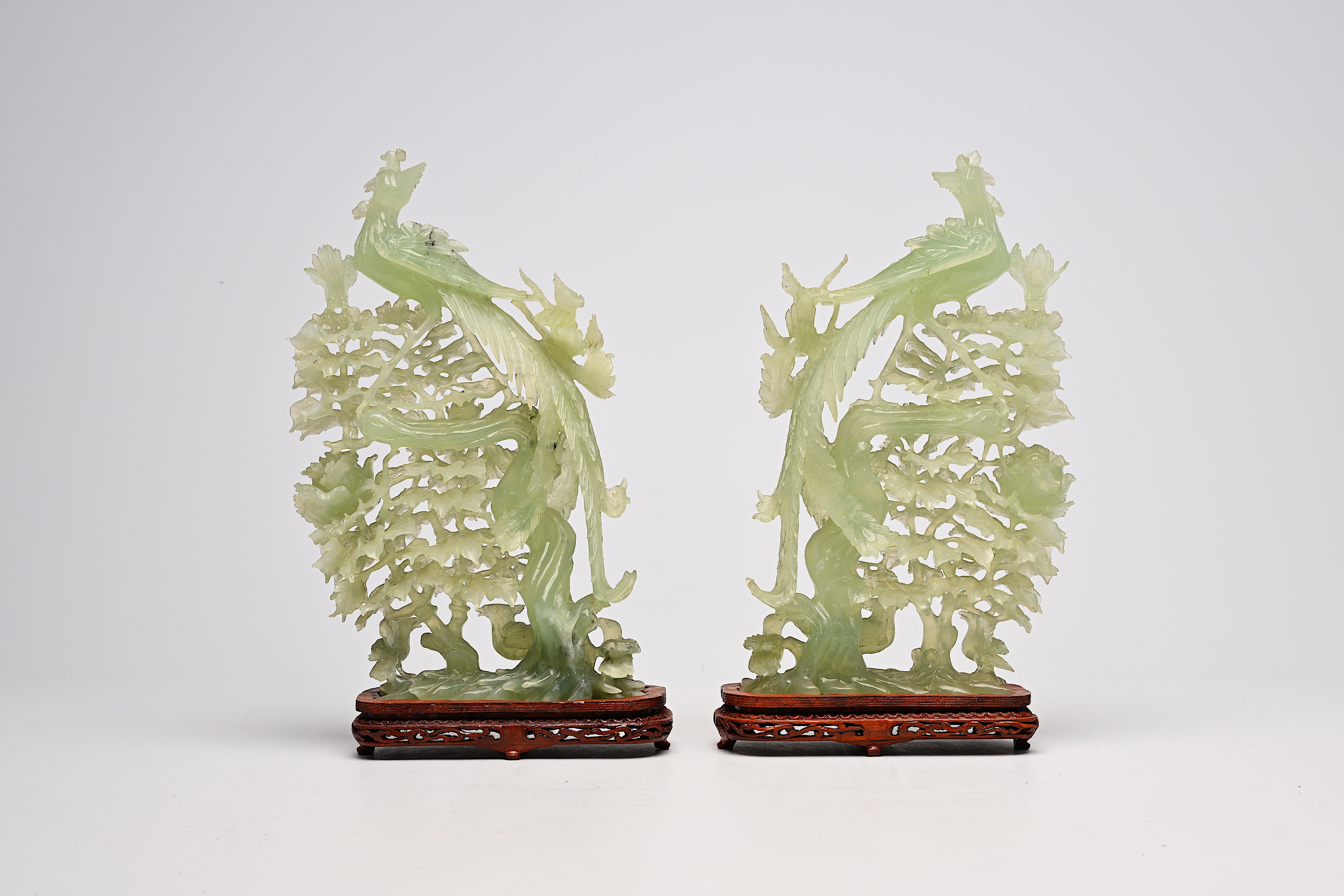 A pair of large Chinese carved jadeite groups with a phoenix among blossoming branches, 20th C. - Image 4 of 6