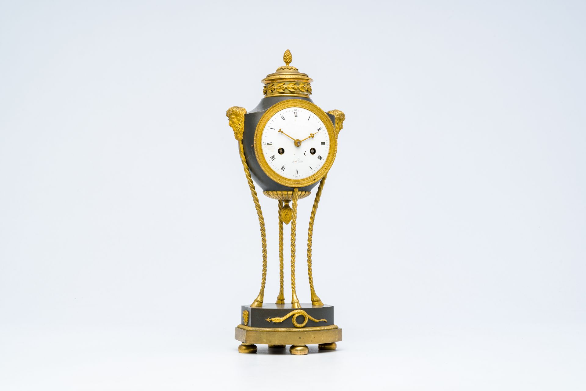 An elegant French Neoclassical patinated and gilt bronze mantel clock with mascarons, 19th C. - Image 2 of 9