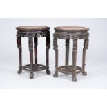 A pair of Chinese reticulated hardwood stands with marble tops, 19th/20th C.