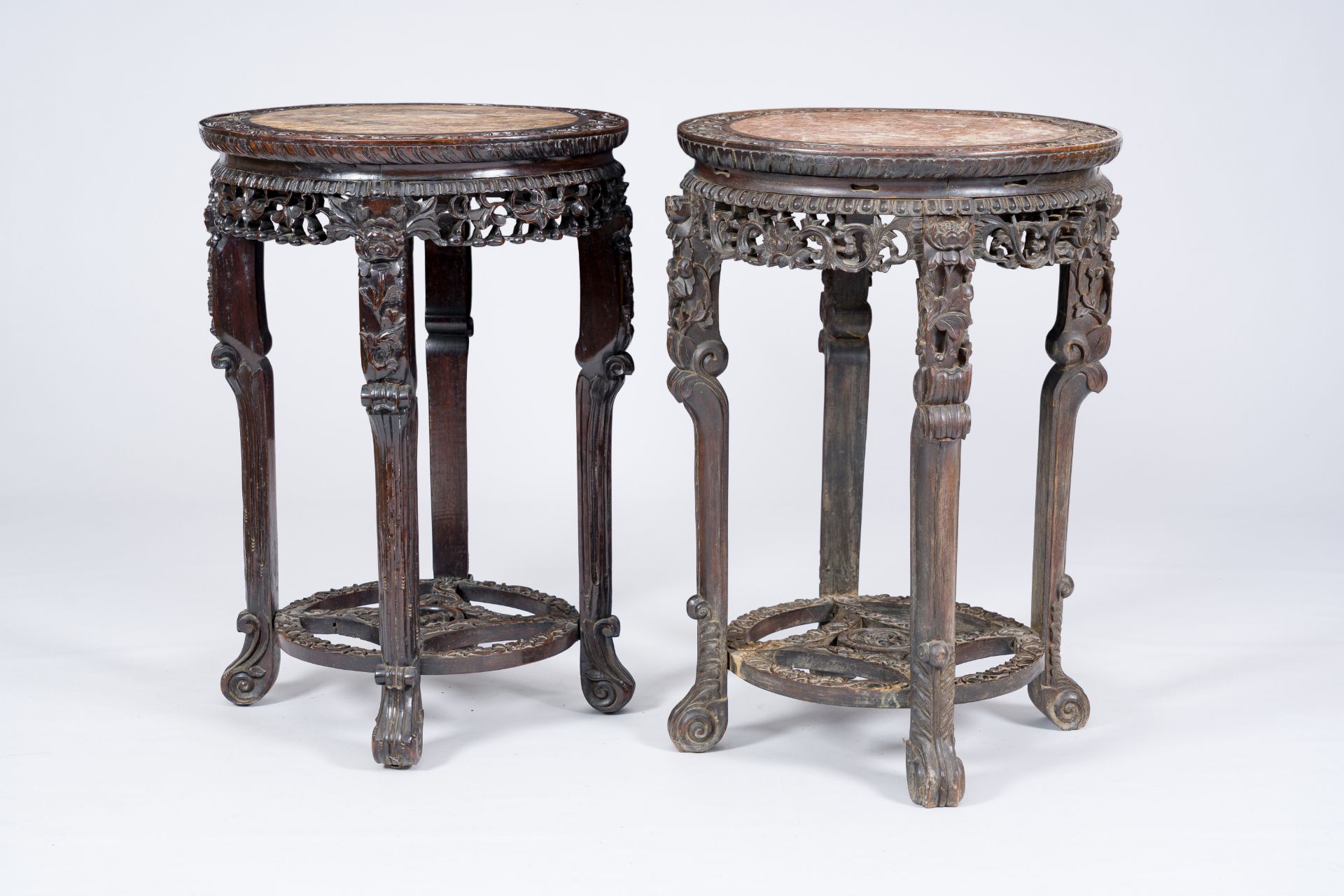 A pair of Chinese reticulated hardwood stands with marble tops, 19th/20th C.