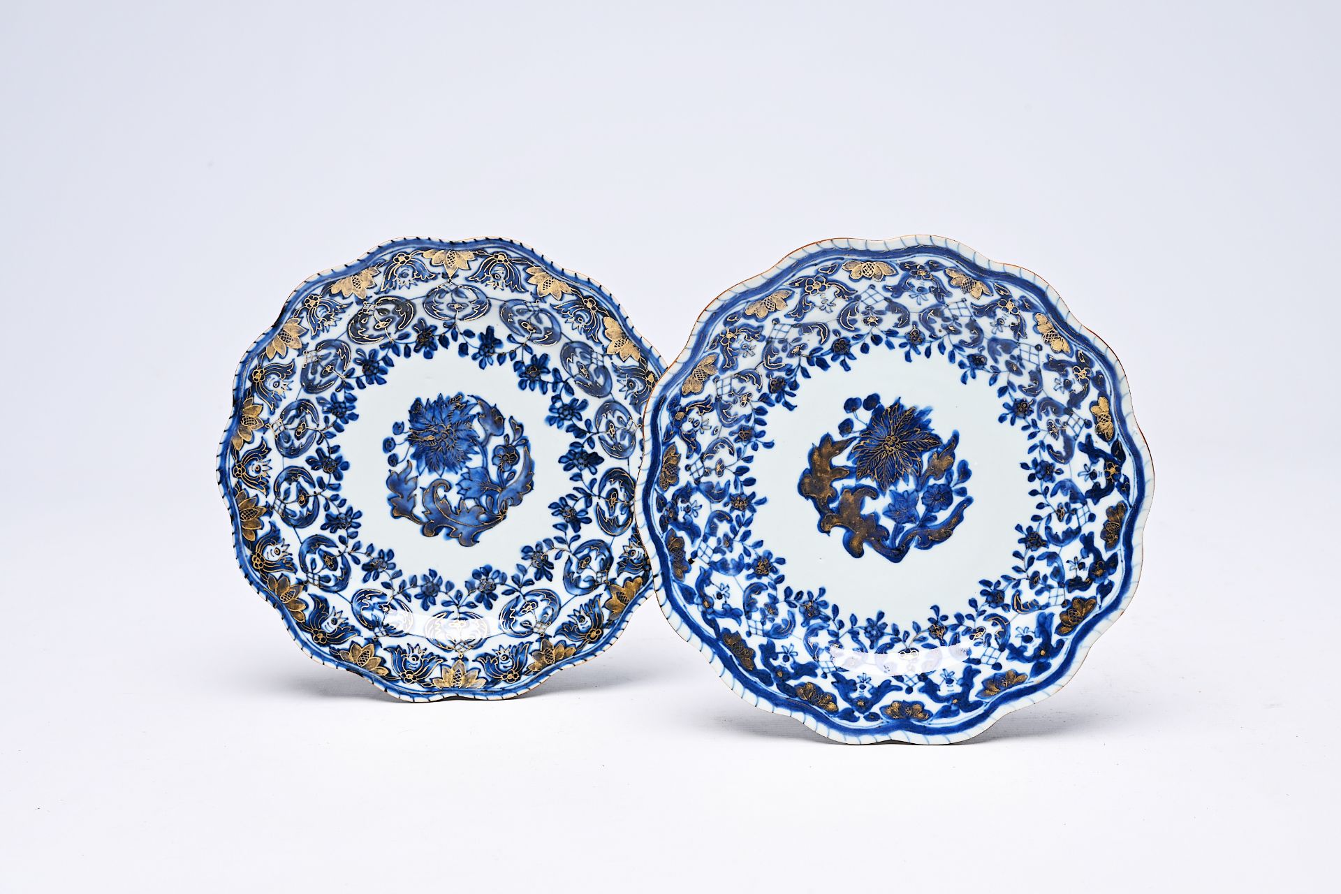 A pair of Chinese lobed blue, white and gilt plates with floral design, Qianlong