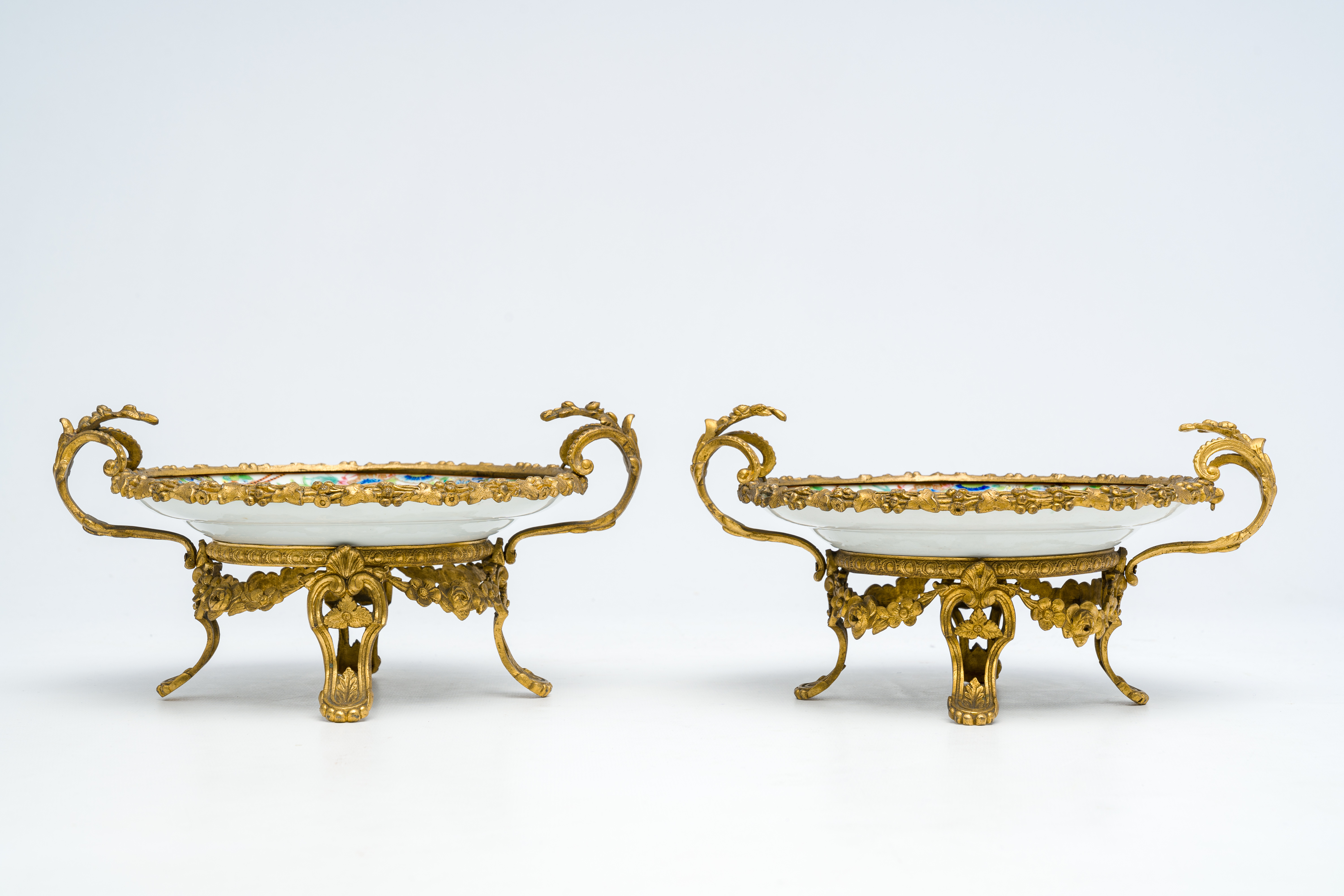 Two Chinese Canton famille rose gilt bronze mounted plates with figures on a terrace, 19th C. - Image 4 of 7