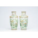 A pair of Chinese Canton famille rose vases with birds among blossoming branches, 19th C.
