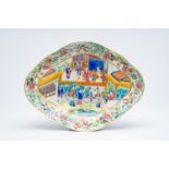 A Chinese Canton famille rose lobed bowl on foot with an animated palace scene and floral design, 19