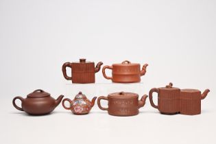 Six various Chinese Yixing stoneware teapots and covers one with enamelled design, 19th/20th C.