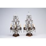 A pair of French Louis XIV style patinated bronze and cut crystal six-lights girandoles, early 20th