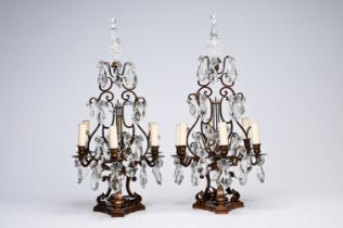 A pair of French Louis XIV style patinated bronze and cut crystal six-lights girandoles, early 20th