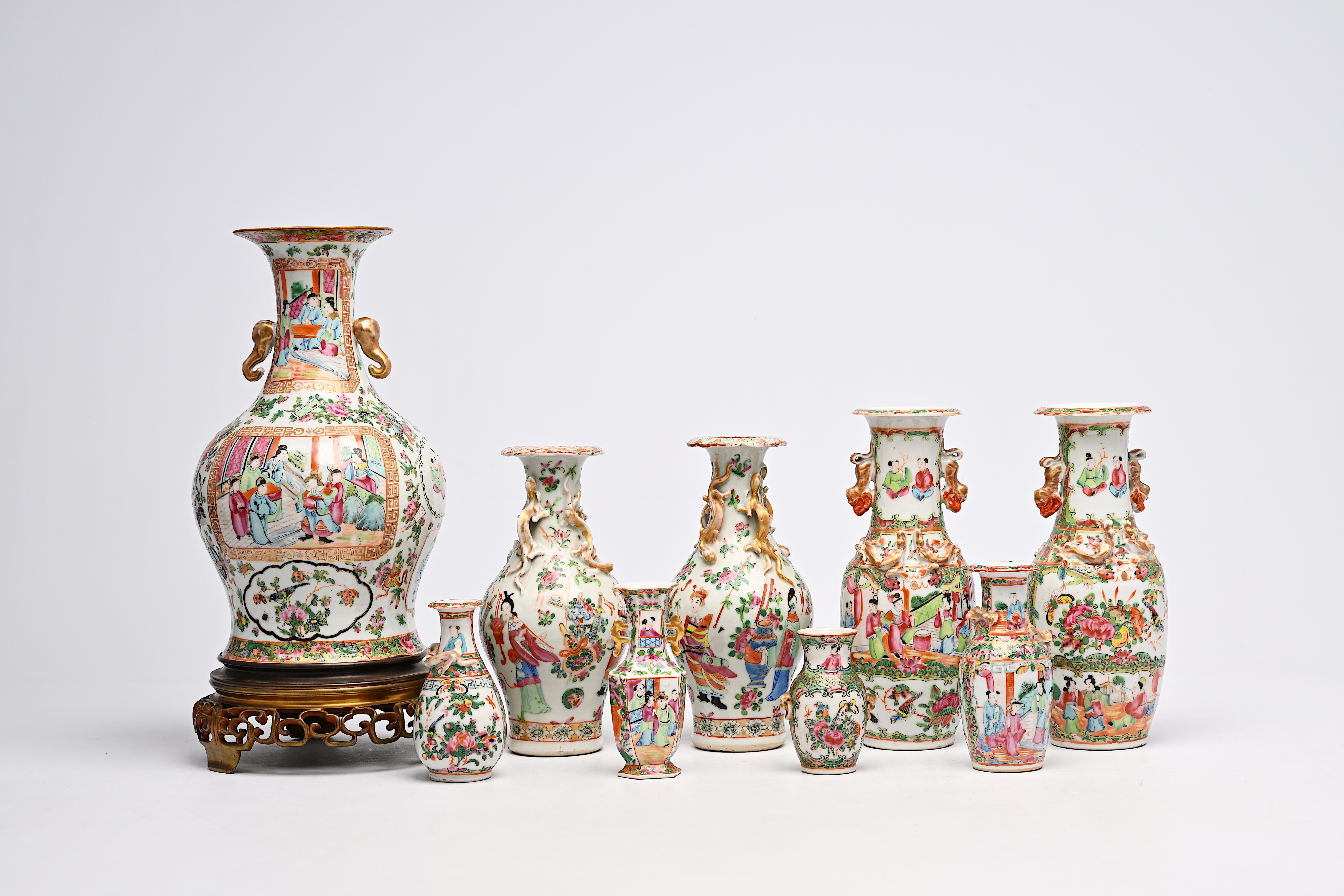 A varied collection of nine Chinese Canton famille rose vases, including two pairs, 19th C.