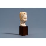 A fine ivory bust of an African beauty on a wood base, probably Belgium, late 19th C.