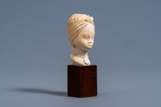 A fine ivory bust of an African beauty on a wood base, probably Belgium, late 19th C.