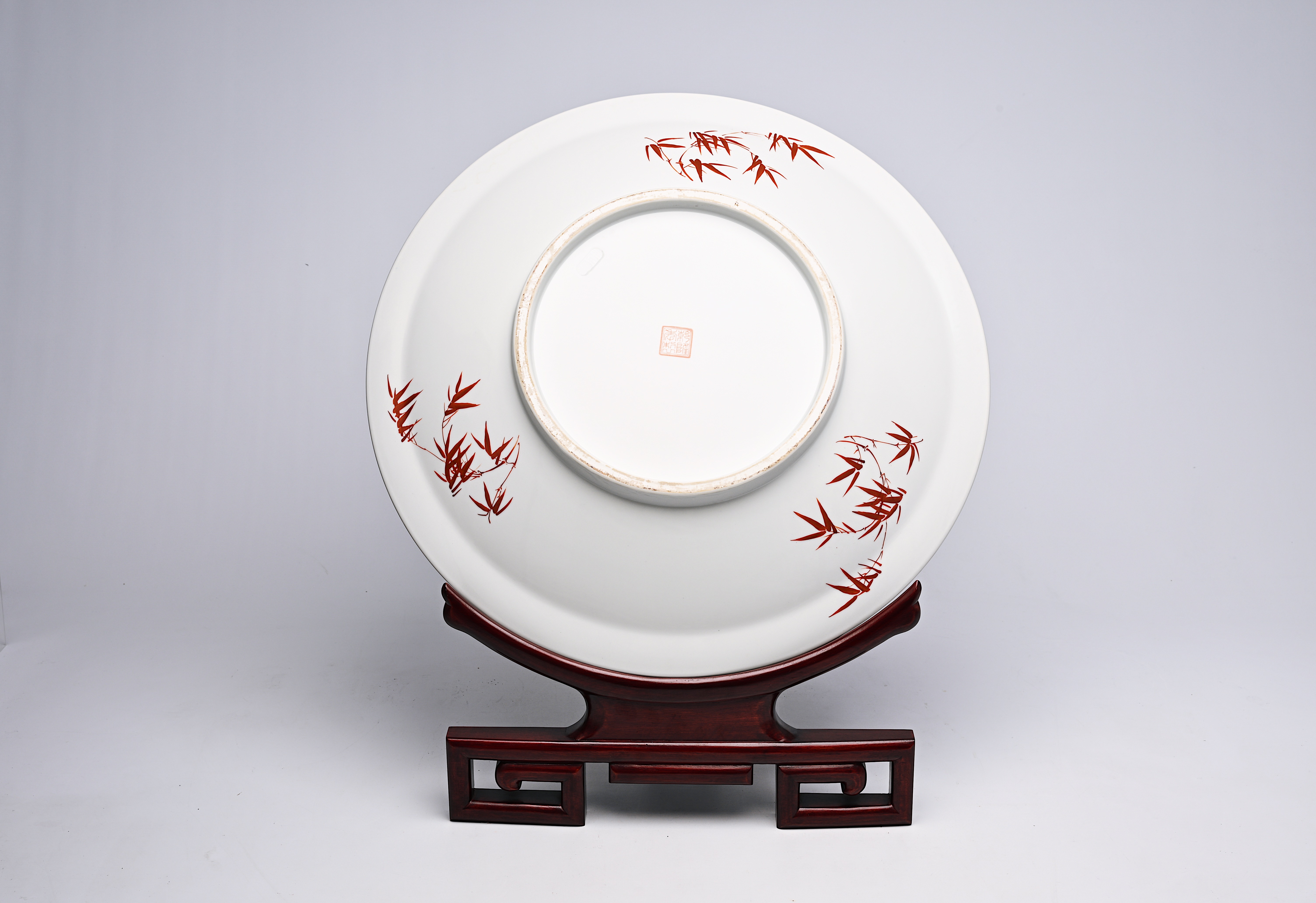 A large Chinese famille rose dish with ladies and children in a landscape, Qianlong mark, 20th C. - Image 4 of 16