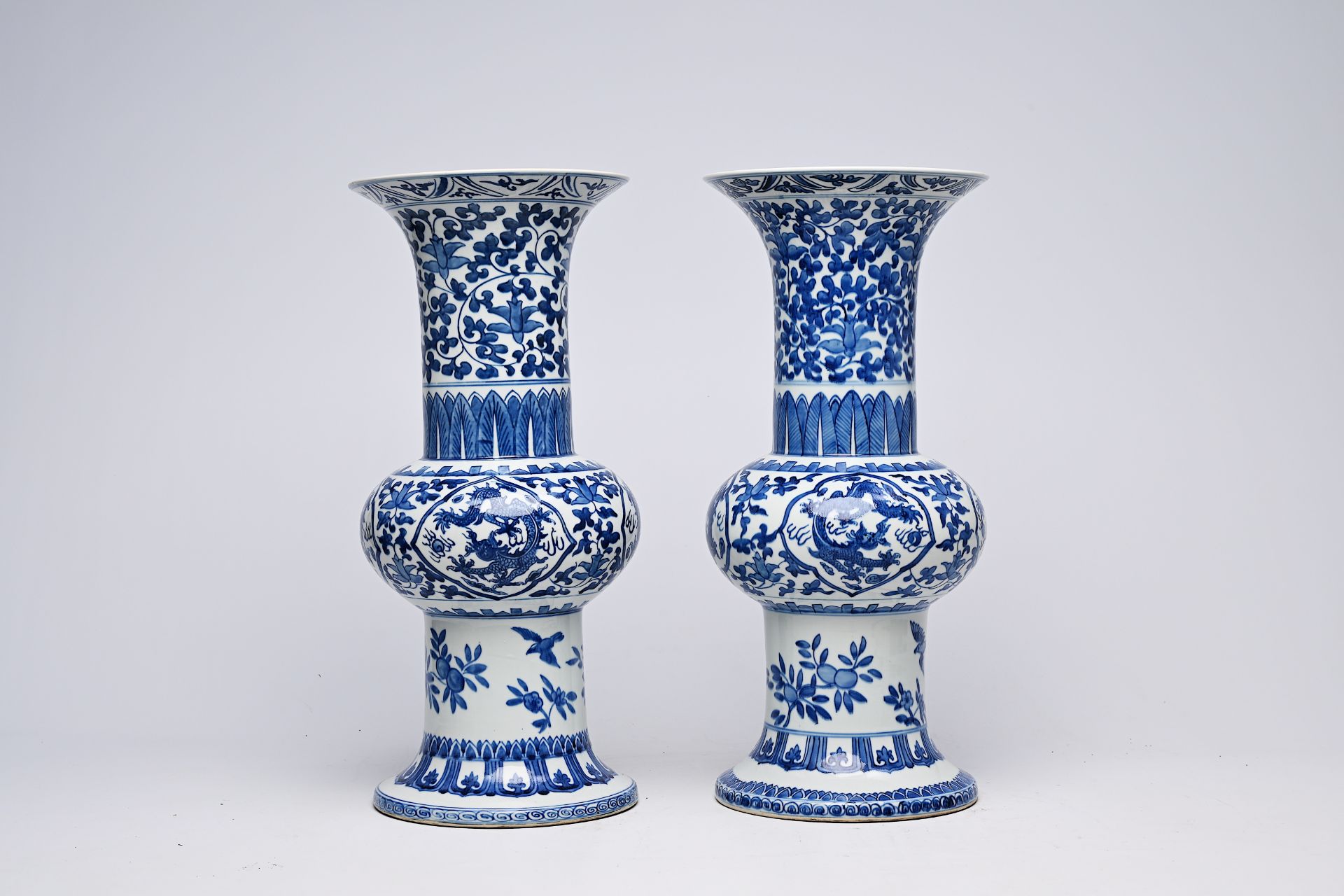 A pair of Chinese blue and white 'gu' vases with dragons and floral design, Qianlong mark, Republic, - Image 4 of 22