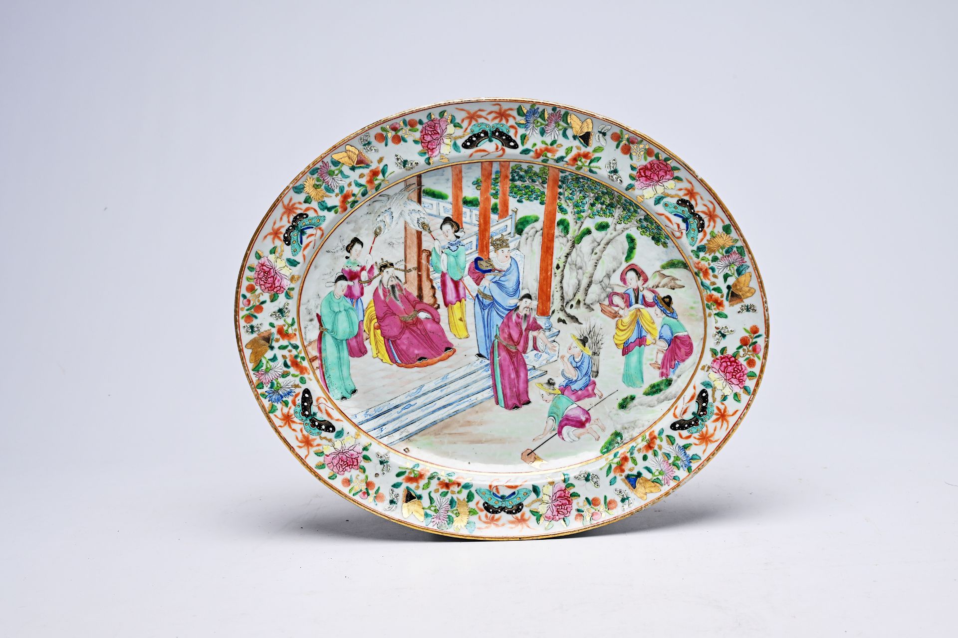 A large Chinese Canton famille rose oval dish with farmers in an audience with the emperor, 19th C.
