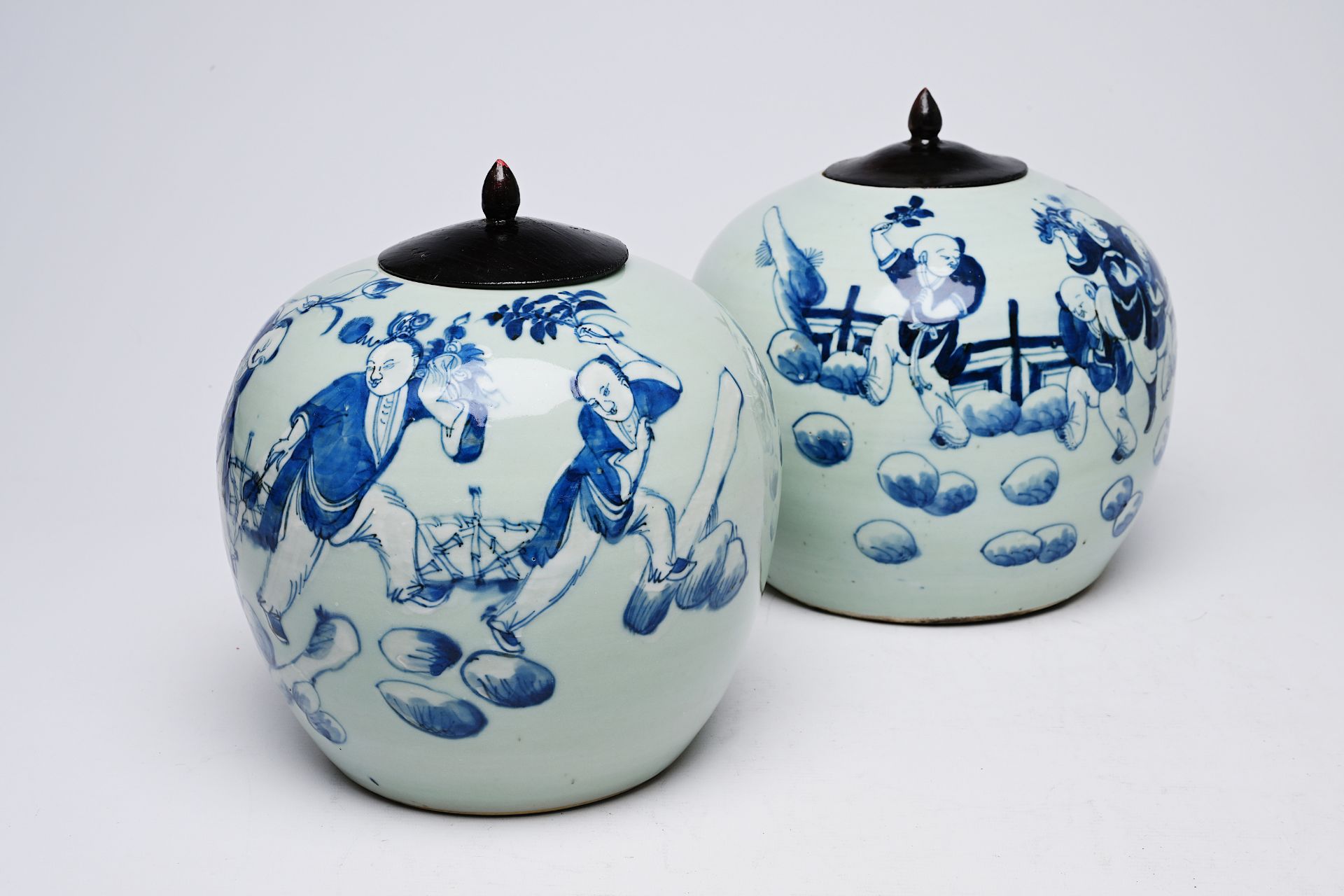 Two Chinese blue and white celadon ground jars and covers with playing children on a terrace, 19th/2