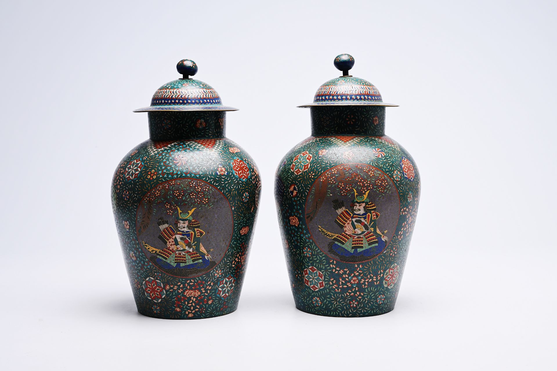 A pair of Japanese cloisonne 'dragon and samurai' vases and covers, Meiji, ca. 1900