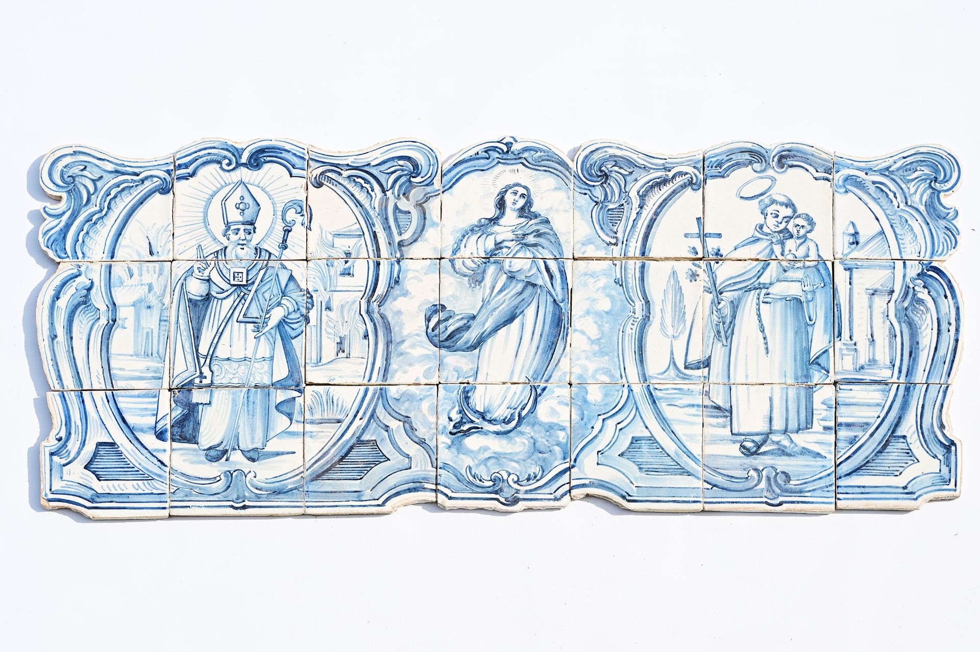 A Portuguese blue and white tile mural with the Madonna and two saints, late 18th C.