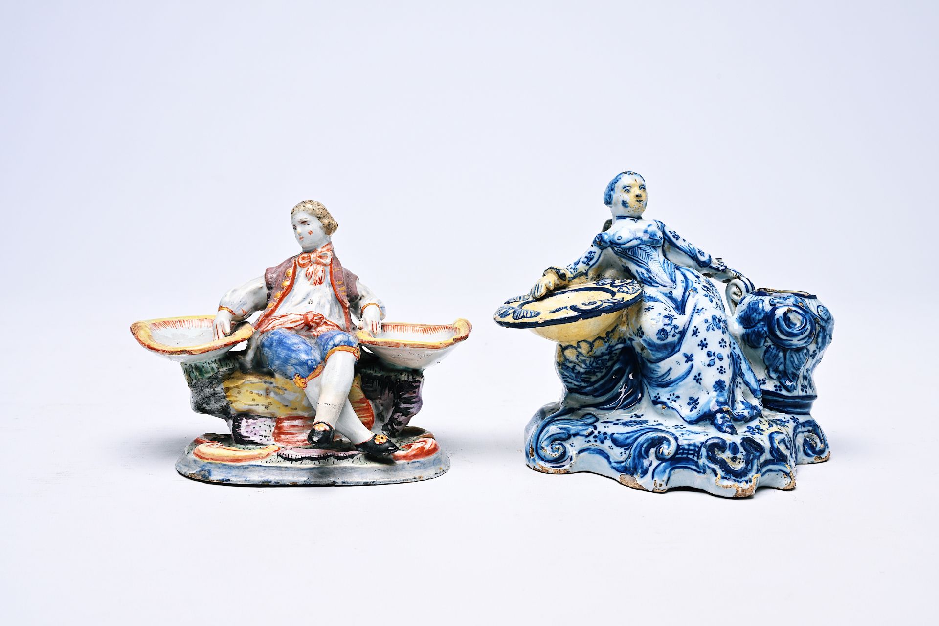 Two Dutch Delft blue and white and polychrome salts in the form of a man and a woman, 18th/19th C.