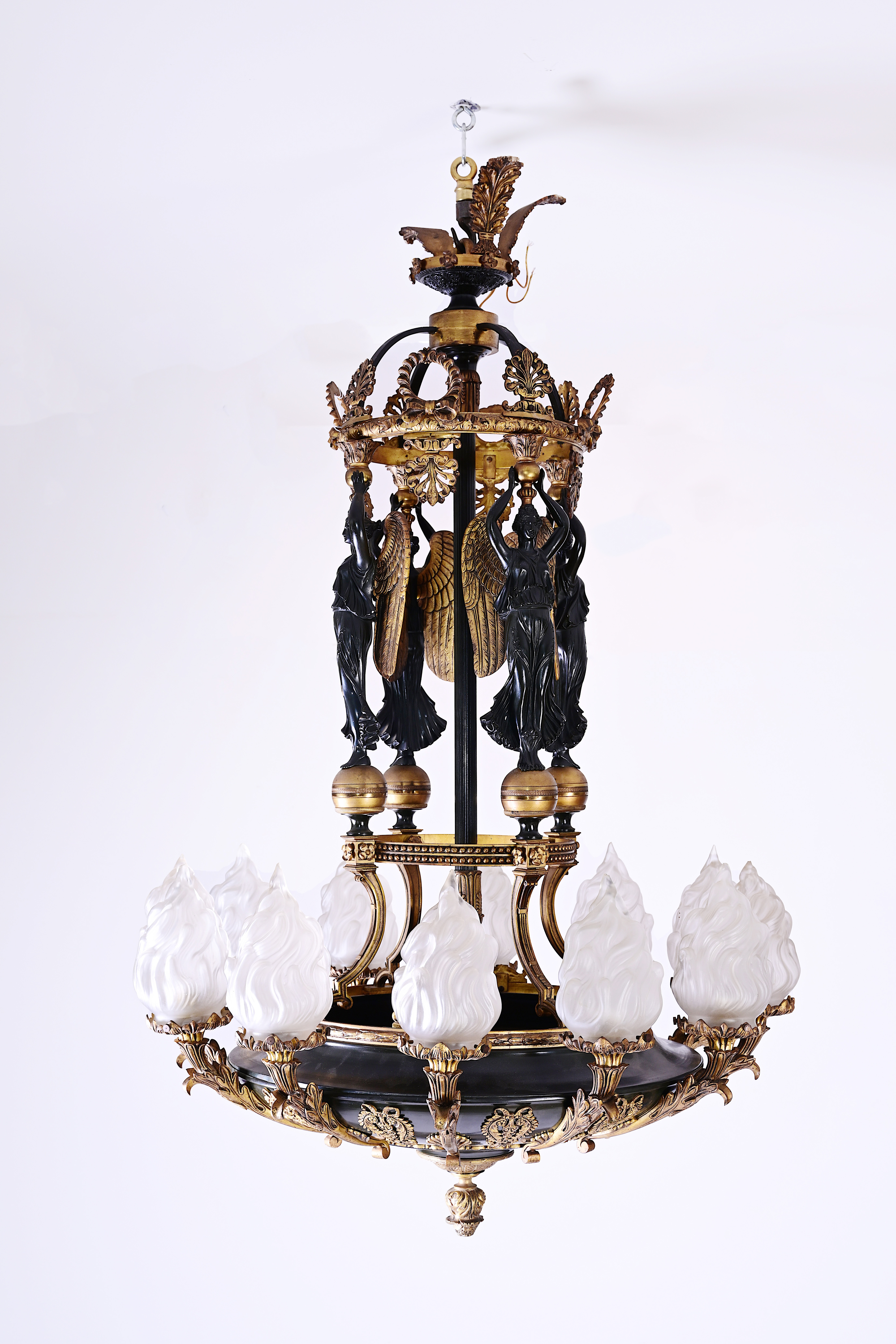 A French patinated and gilt bronze Empire style twelve-light 'caryatids' chandelier, 19th C.