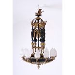 A French patinated and gilt bronze Empire style twelve-light 'caryatids' chandelier, 19th C.