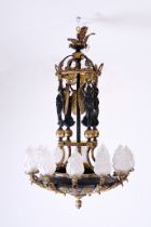 A French patinated and gilt bronze Empire style twelve-light 'caryatids' chandelier, 19th C.